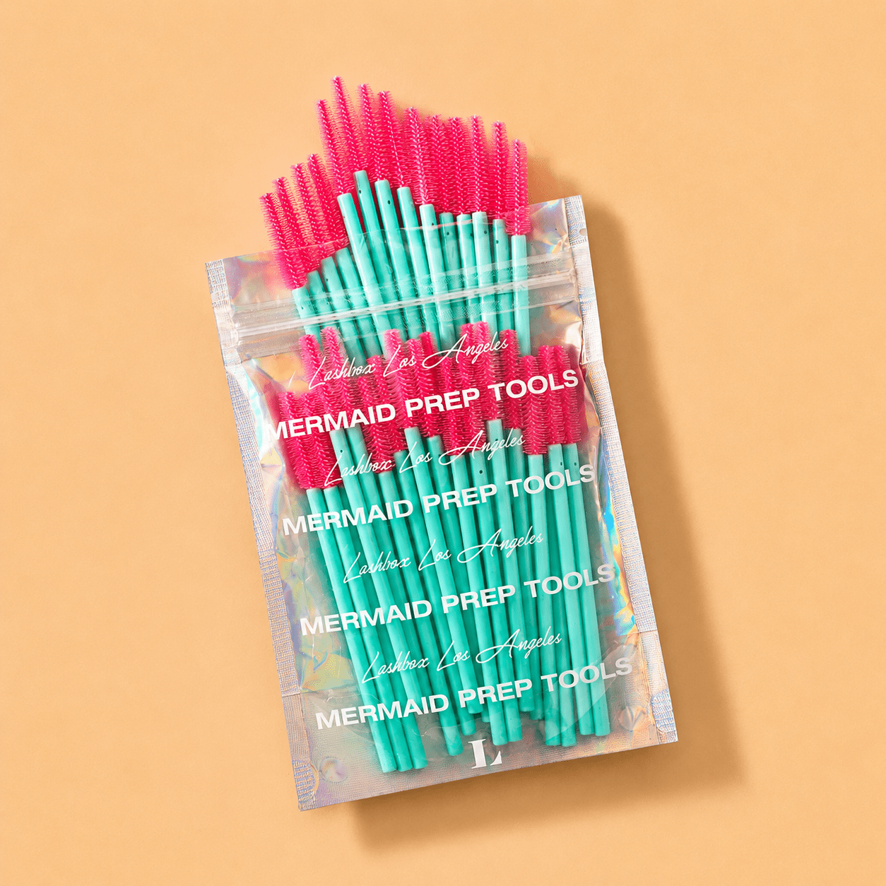 Teal and pink LBLA Silicone Mascara Wands displayed next to their branded outer packaging.