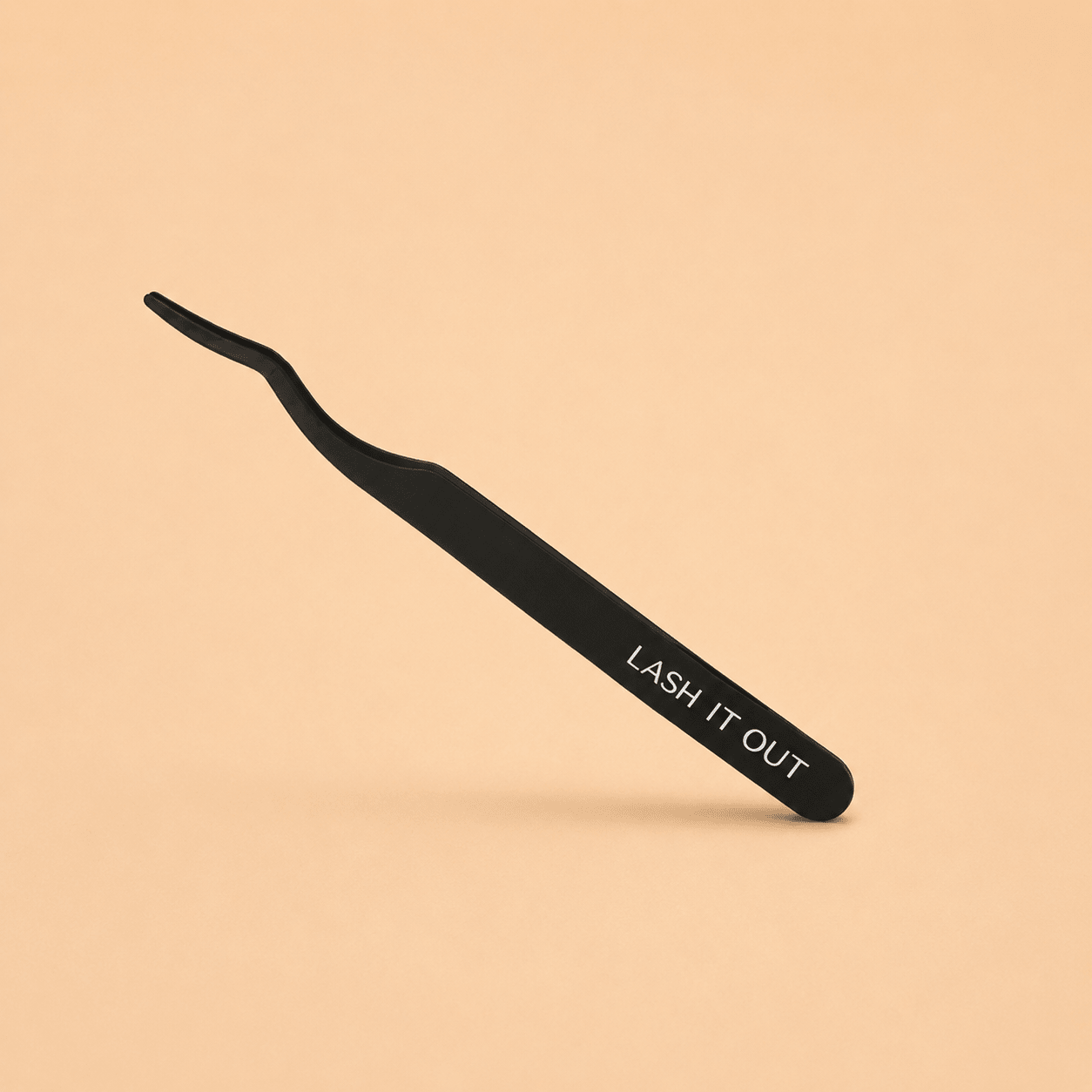 Lash It Out Curved Lash Applicator Tweezer displayed standing next to its branded outer packaging.